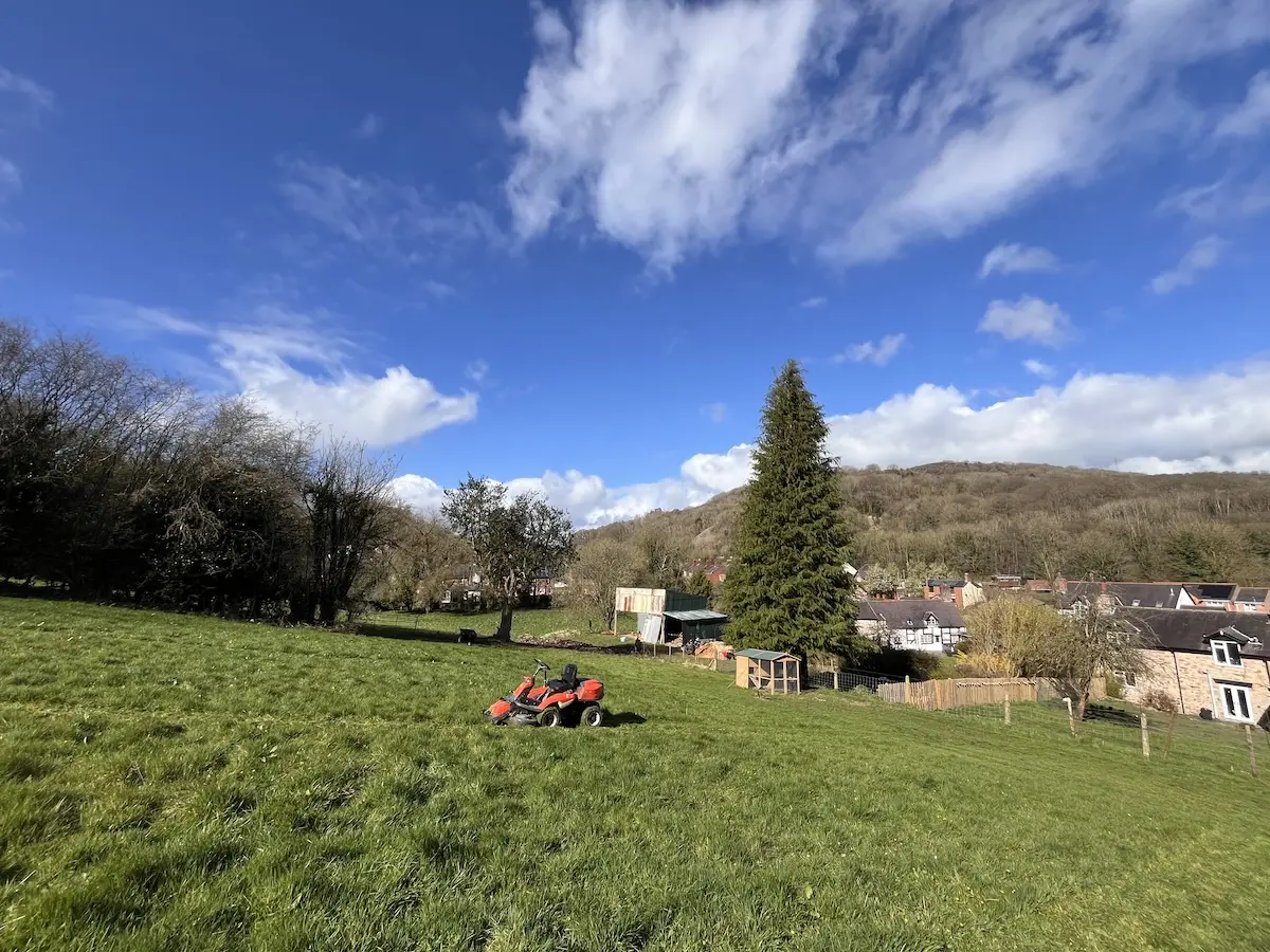 Side view of our mower in the same field