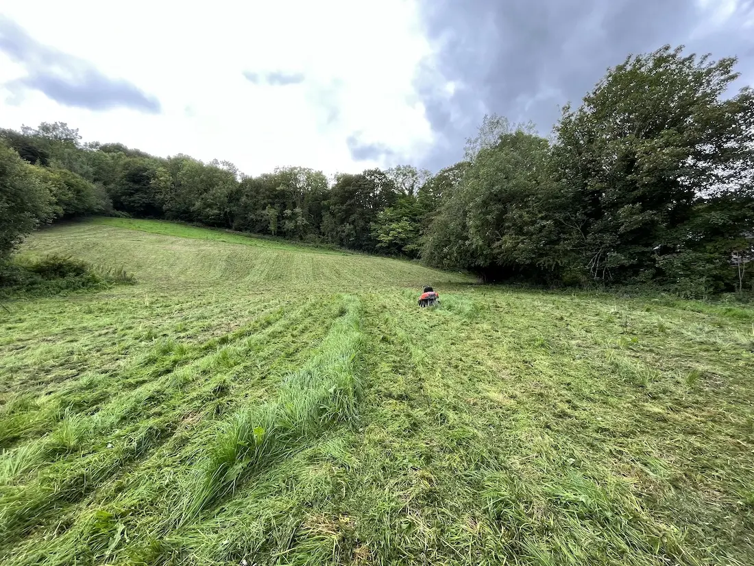 A close up of my dead mower in a large field